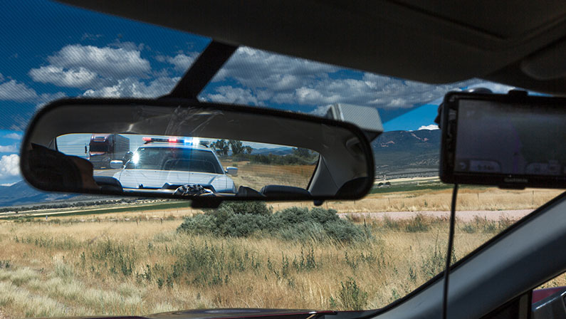 Cop lights in the rearview mirror